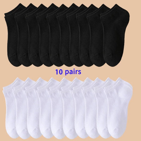 10 pairs of black socks on top and 10 pairs of white socks on bottom against a beige background.