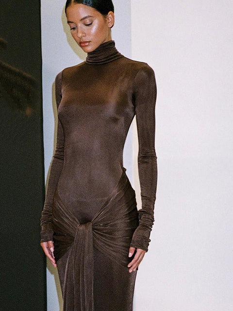 Woman wearing a brown bodysuit with a white background