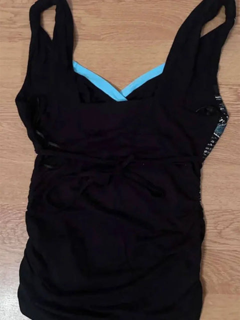 Black swimsuit with blue lining on a wooden surface