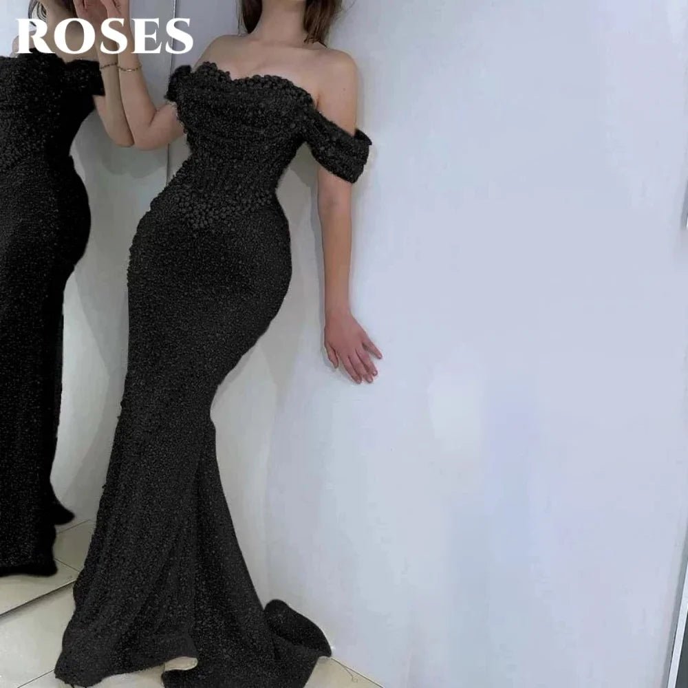 Black off-shoulder evening gown with 'ROSES' text above