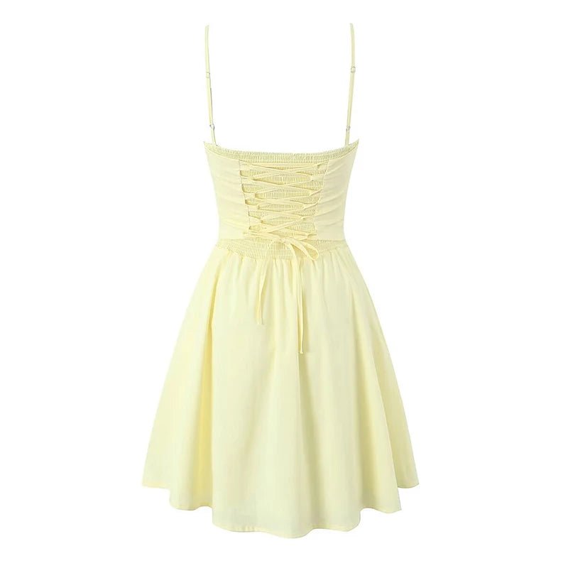 Light yellow dress with thin straps on a white background
