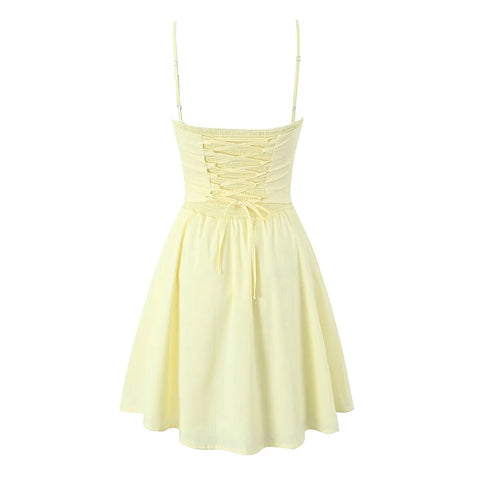 Light yellow dress with thin straps on a white background