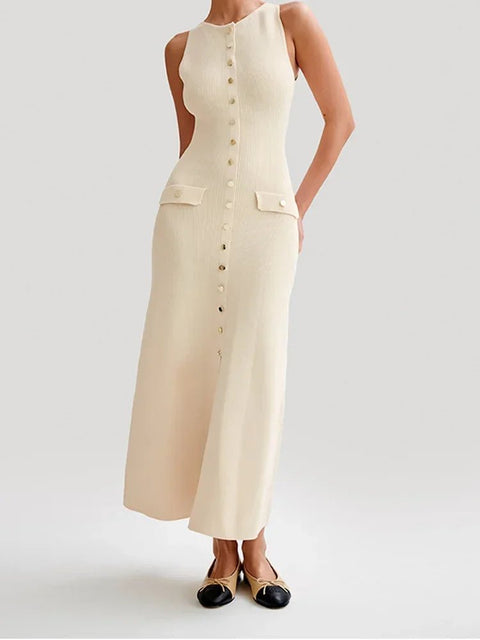 Woman wearing a beige sleeveless dress with buttons on a white background