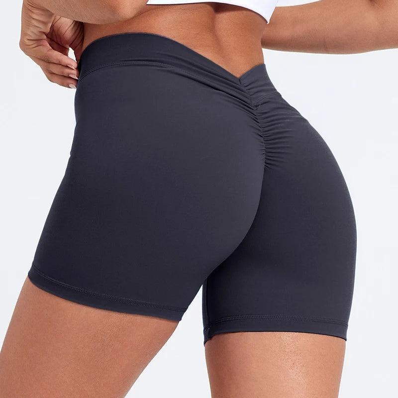 Black athletic shorts worn by a person on a light gray background