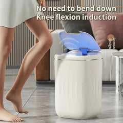 White Smart Sensor Trash Can with blue light on a wooden floor, person using it.