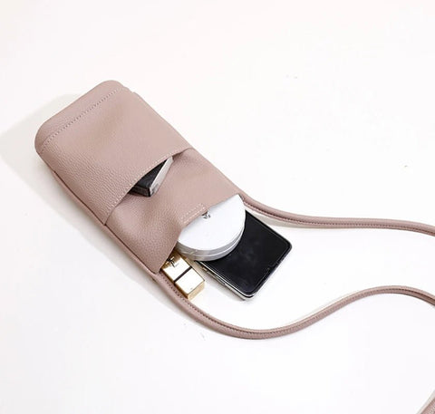 Beige leather case with a phone, white power bank, and gold USB cable on a light beige background