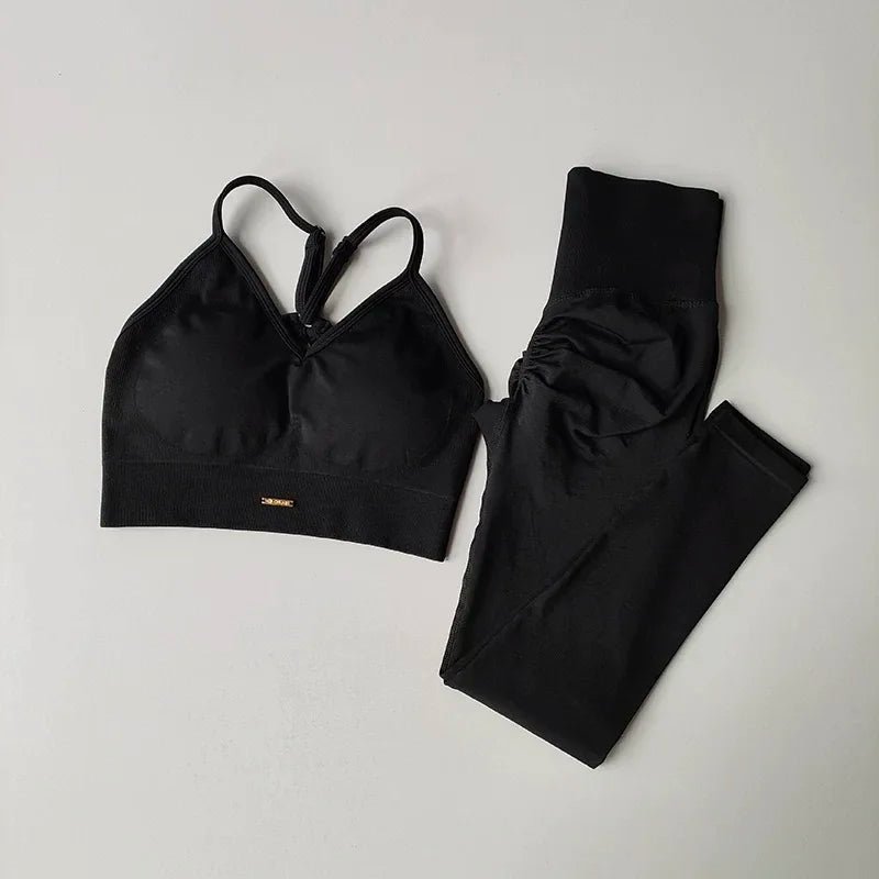 Black sports bra and leggings set on a light gray background