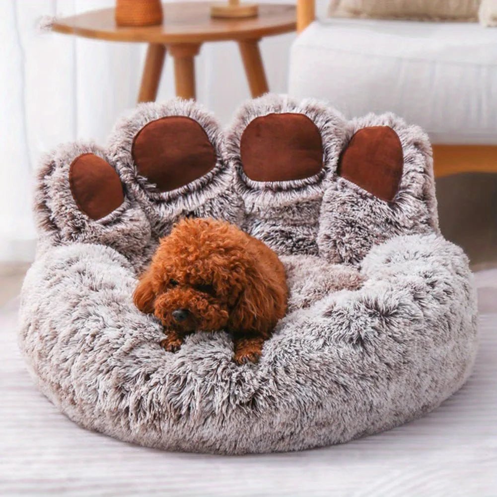 Dog lying on a fluffy, bear-shaped pet bed in a cozy living room.
