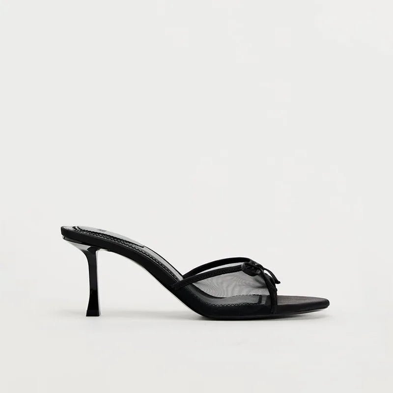 Black high-heeled sandal on a white background