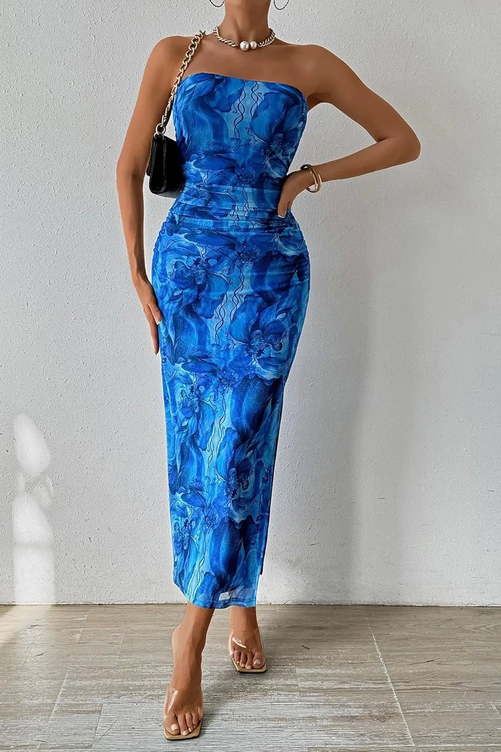 Woman wearing a blue strapless dress with a white background