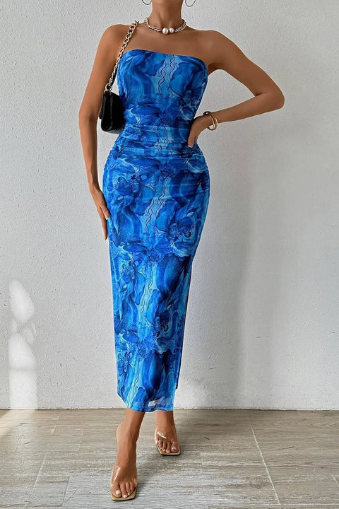 Woman wearing a blue strapless dress with a white background