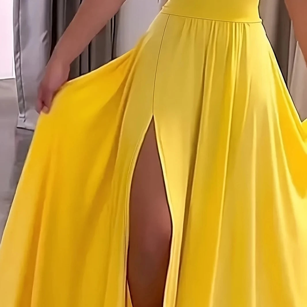 Yellow dress with a high slit on a neutral background