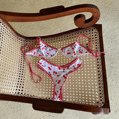 Bikini set with cherry pattern on a wicker chair