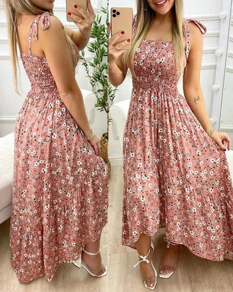 Woman wearing a pink floral dress in a home setting