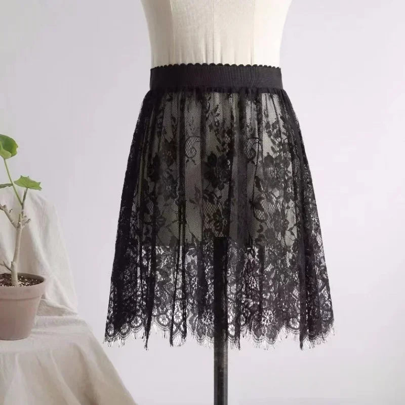 Black lace skirt on a mannequin against a white background