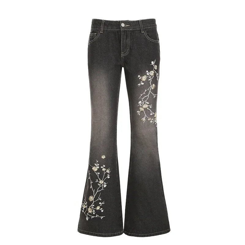 Black flared jeans with floral embroidery on a white background