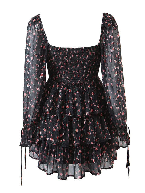 Black floral dress with sheer long sleeves on a white background