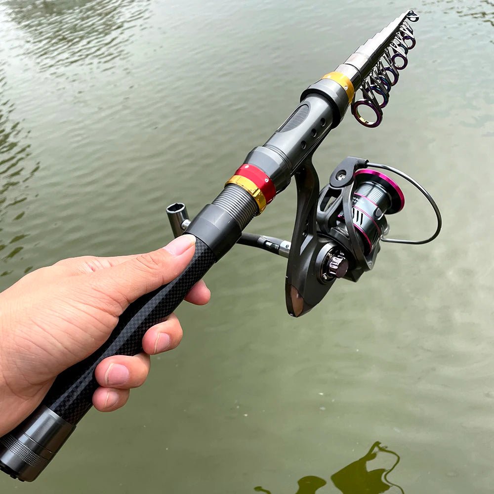 Fishing rod with reel held by a hand over water