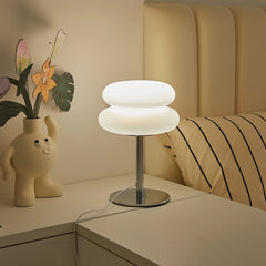 Modern table lamp on a bedside table with decorative elements.