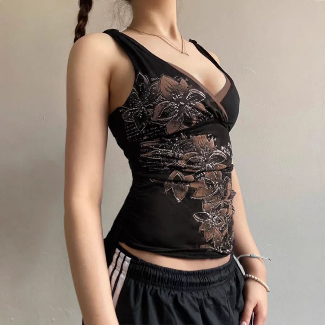 Black lace top worn by a person against a neutral background
