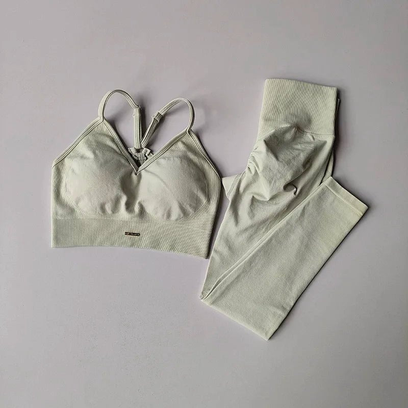 Green bra and pants set on a gray background