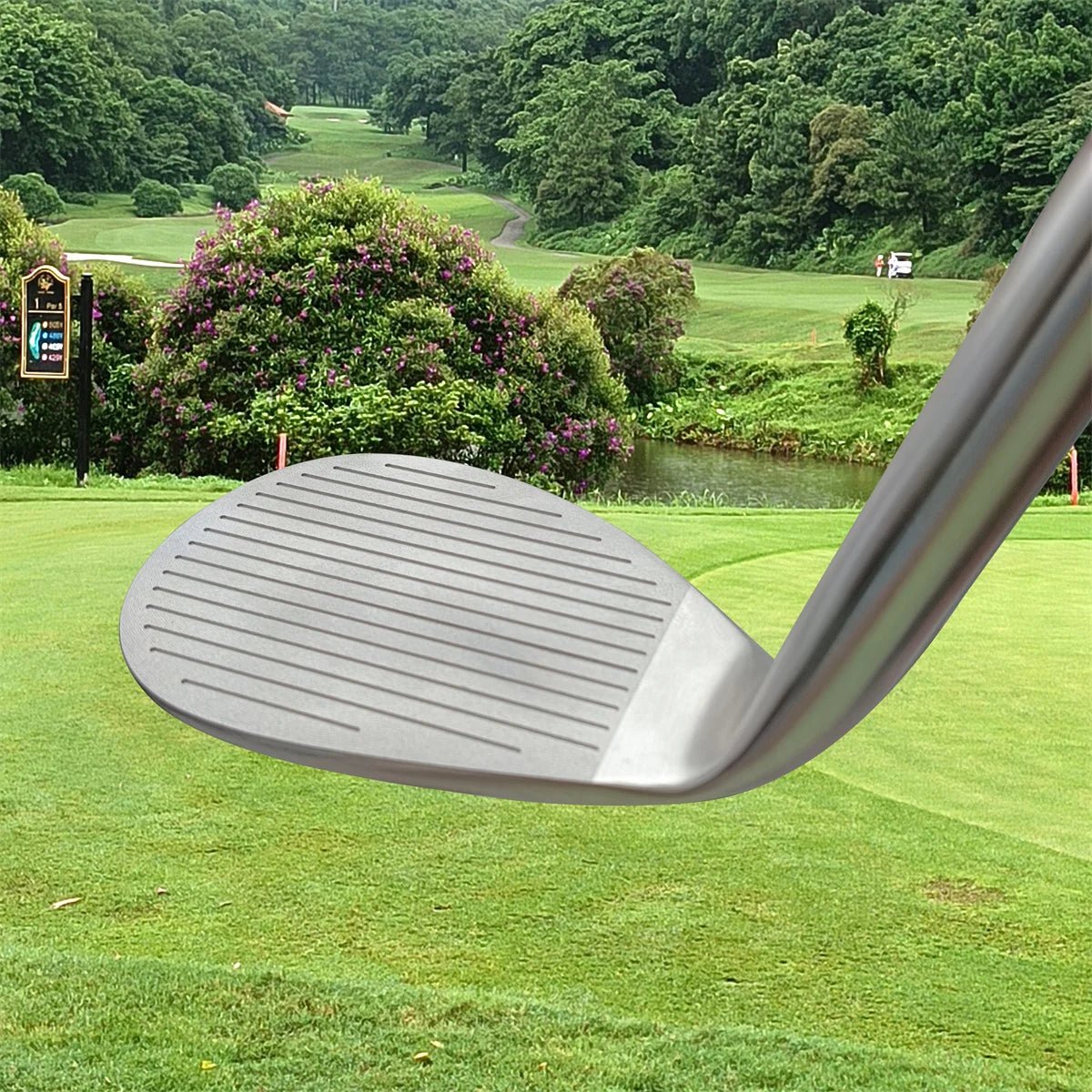 Golf club head with a golf course in the background