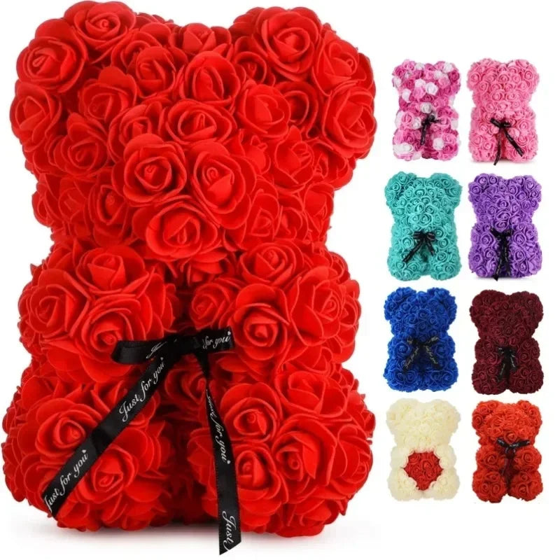 Red rose teddy bear with a black ribbon and additional rose teddy bears in various colors on a white background.