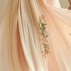 Delicate peach-colored fabric with floral embroidery