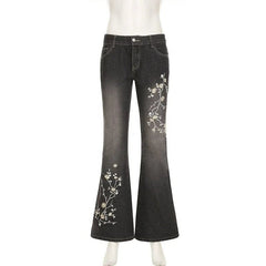 Black jeans with floral embroidery on a white background