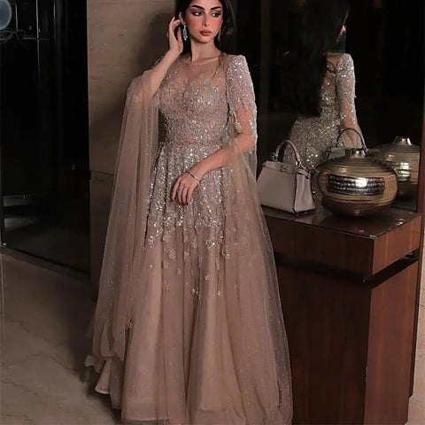Woman in a sparkly dress standing next to a wooden cabinet with decorative items.