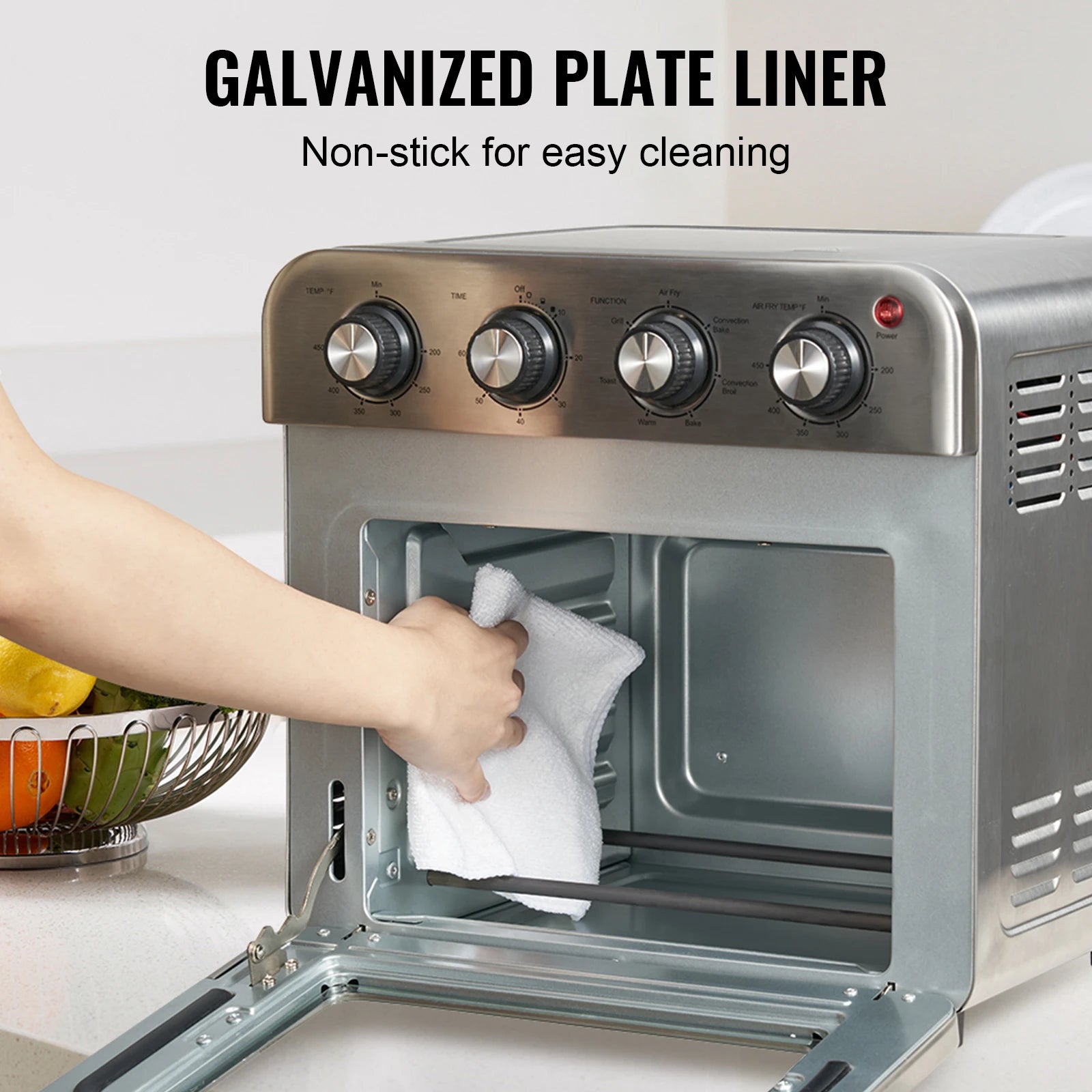 Person cleaning an oven with a towel, featuring text about galvanized plate liner.