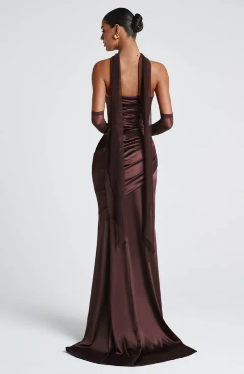 Brown evening gown with a deep neckline and sheer sleeves on a white background