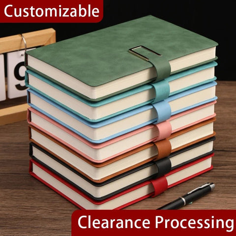 Stack of colorful notebooks with a pen on a wooden surface, featuring customizable and clearance processing text.
