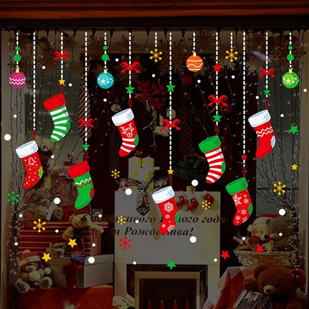 Decorative Christmas window with stockings, ornaments, and a fireplace.