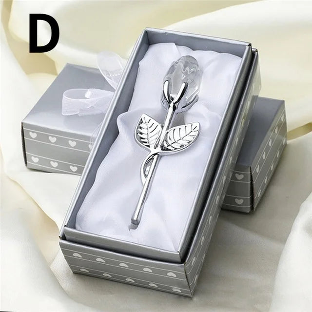 Silver rose-shaped spoon in a decorative box with a white ribbon