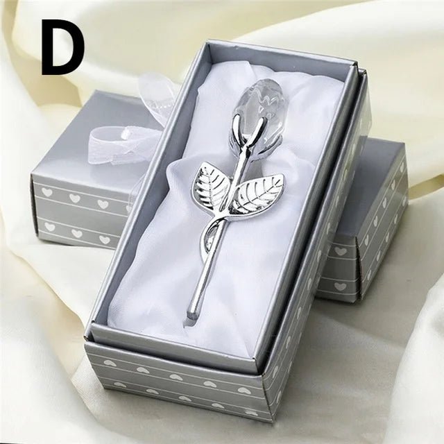 Silver rose-shaped spoon in a decorative box with a white ribbon