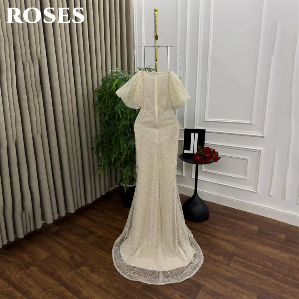 Beige evening gown on a mannequin against a neutral background with 'ROSES' text.