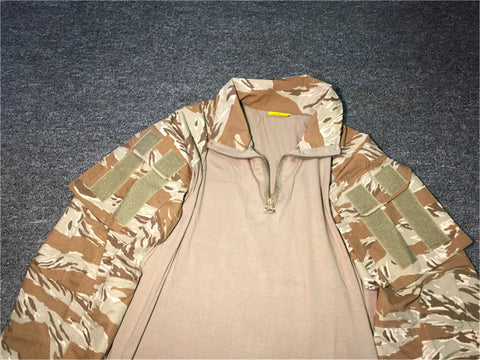 Beige shirt with camouflage sleeves on a dark textured surface