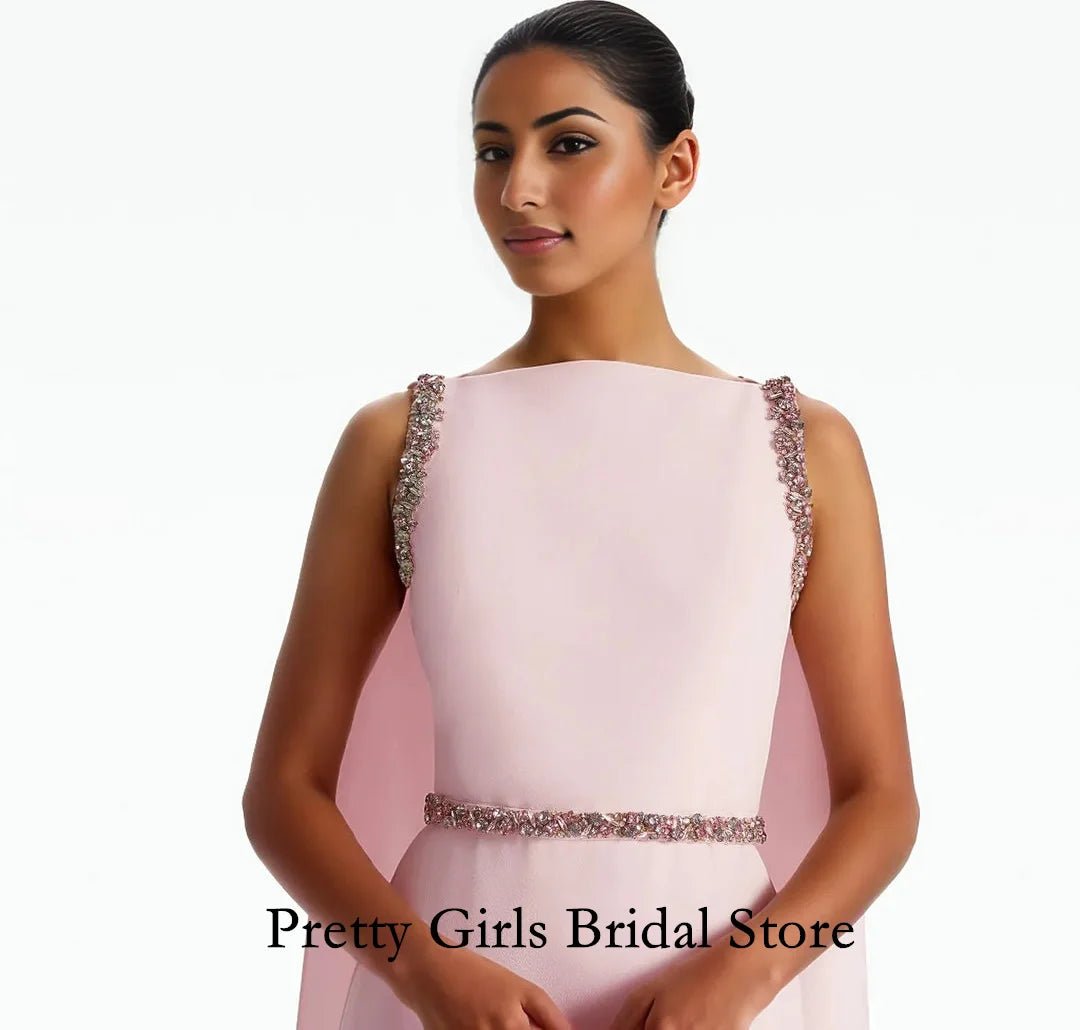 Woman wearing a pink evening gown with embellishments on a white background, branded 'Pretty Girls Bridal Store'.