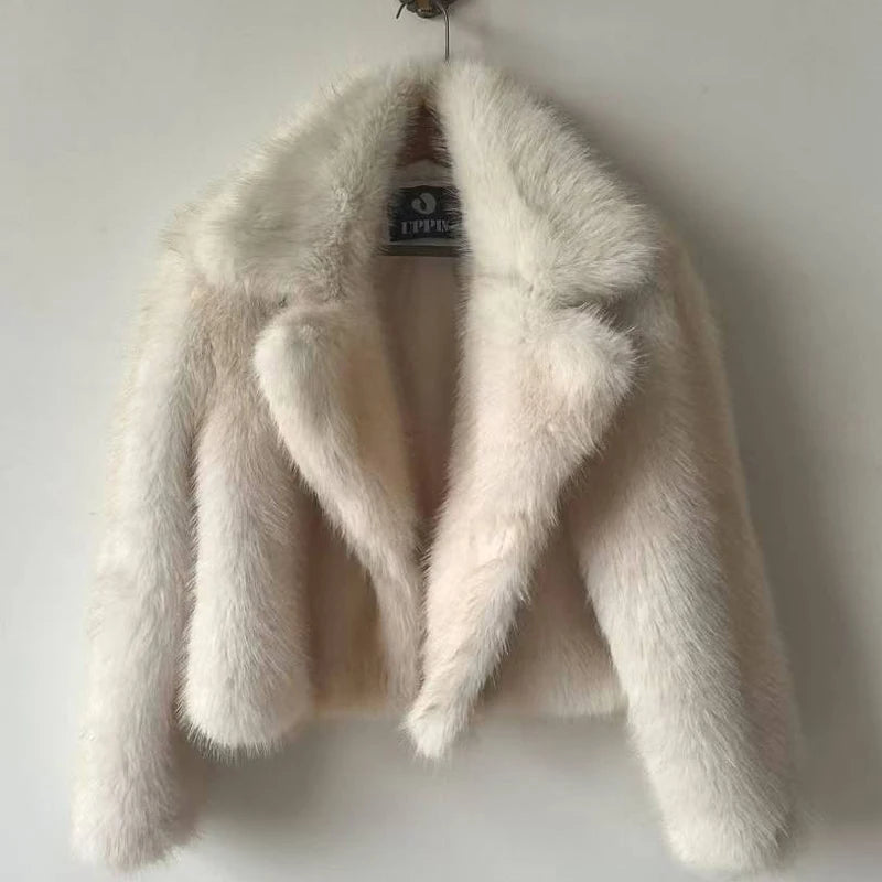 White fur coat on a hanger against a white background