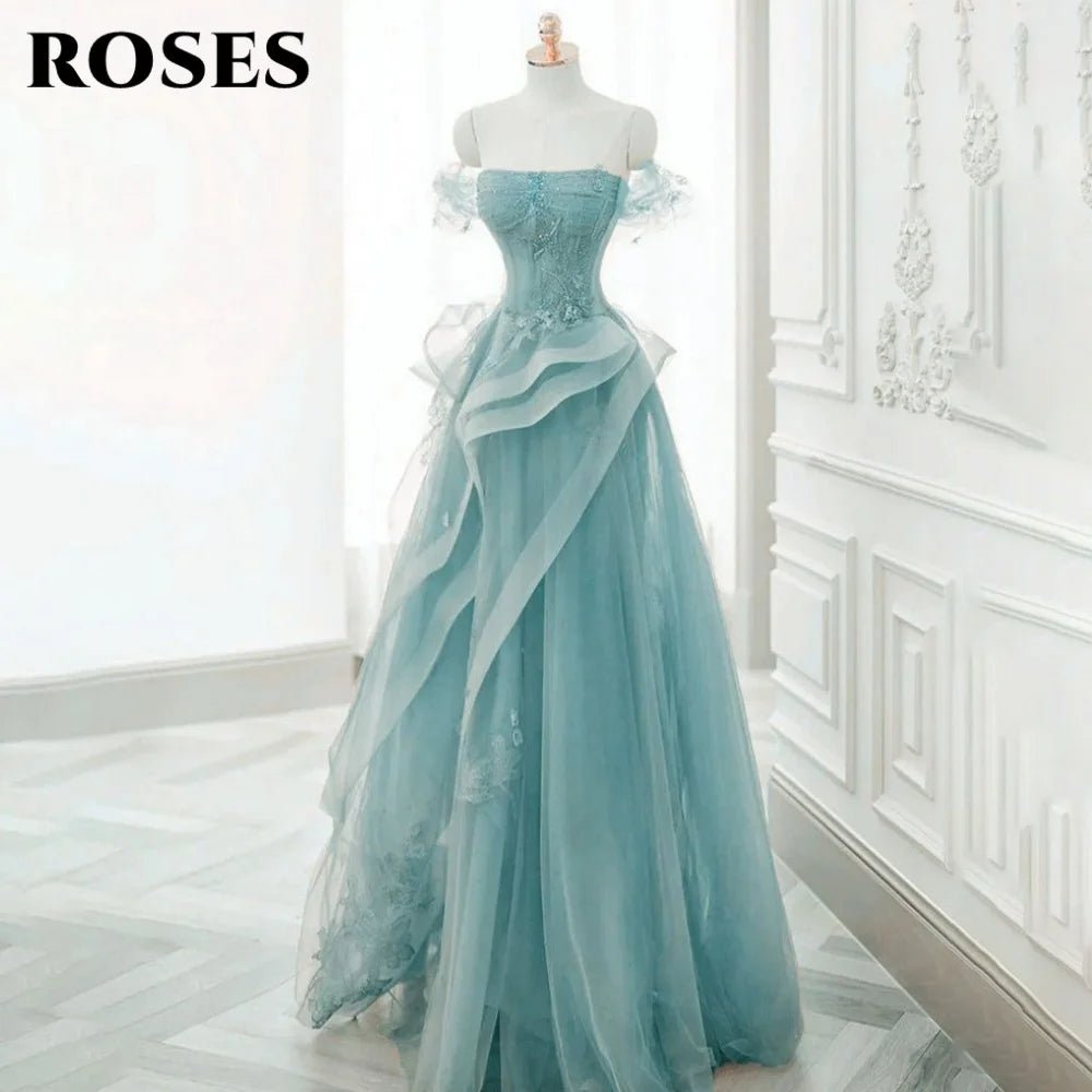 Light blue evening gown on a mannequin against a white wall.