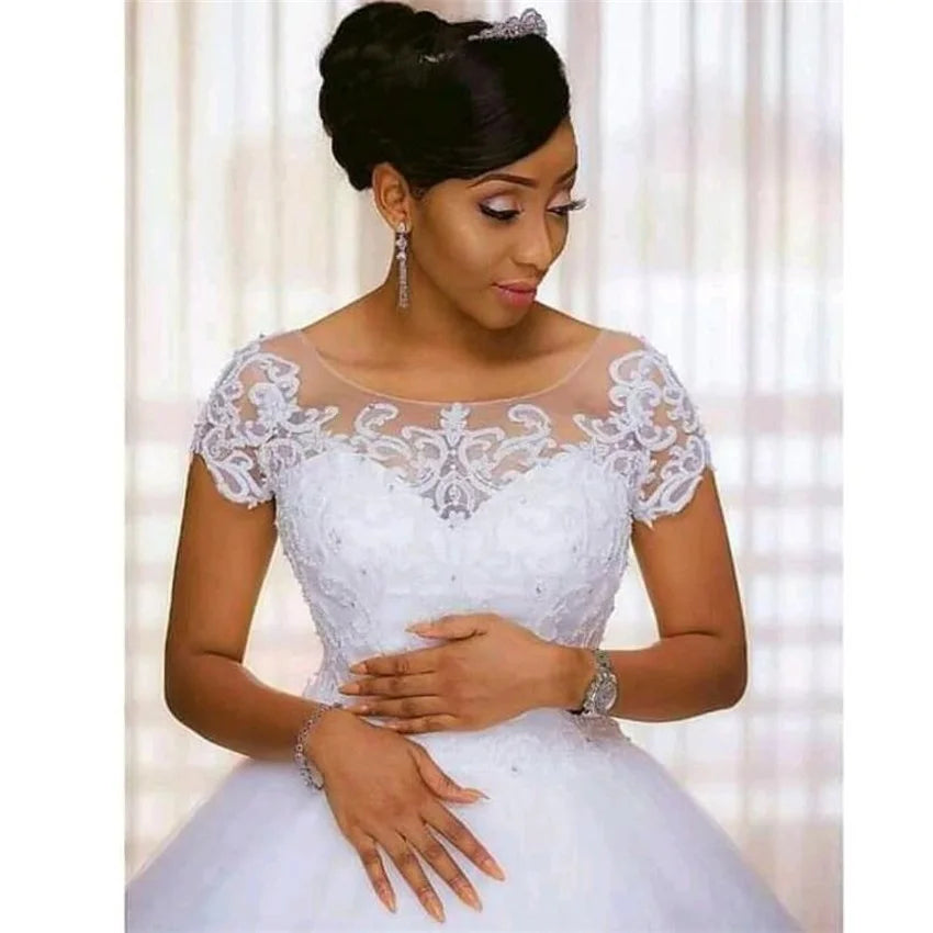 Woman wearing a white lace wedding dress with a blurred background