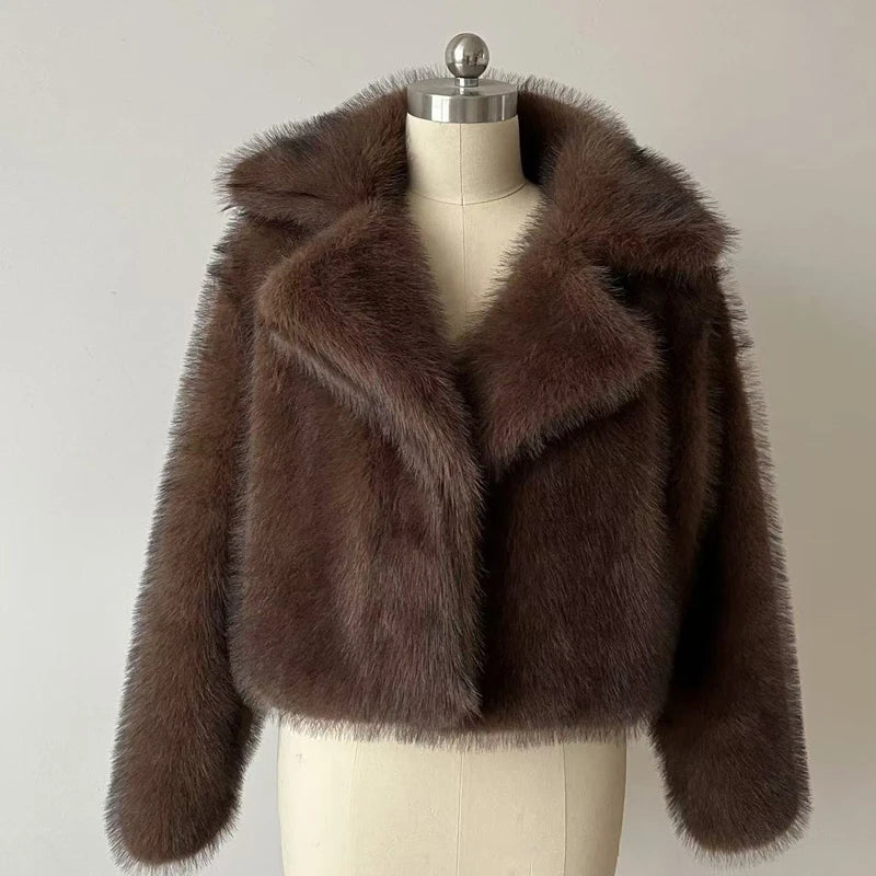 Brown faux fur jacket on a mannequin against a plain background