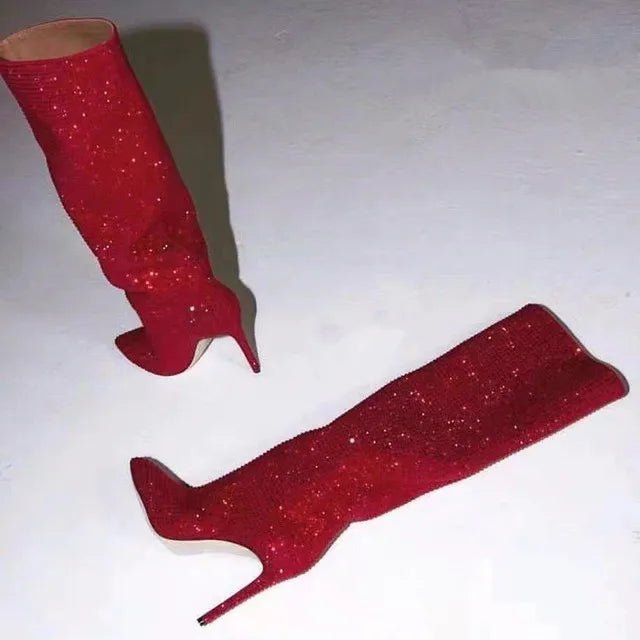 Red glittery high-heeled boots on a white background