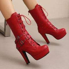 Red high-heeled platform boots with buckles on a neutral background