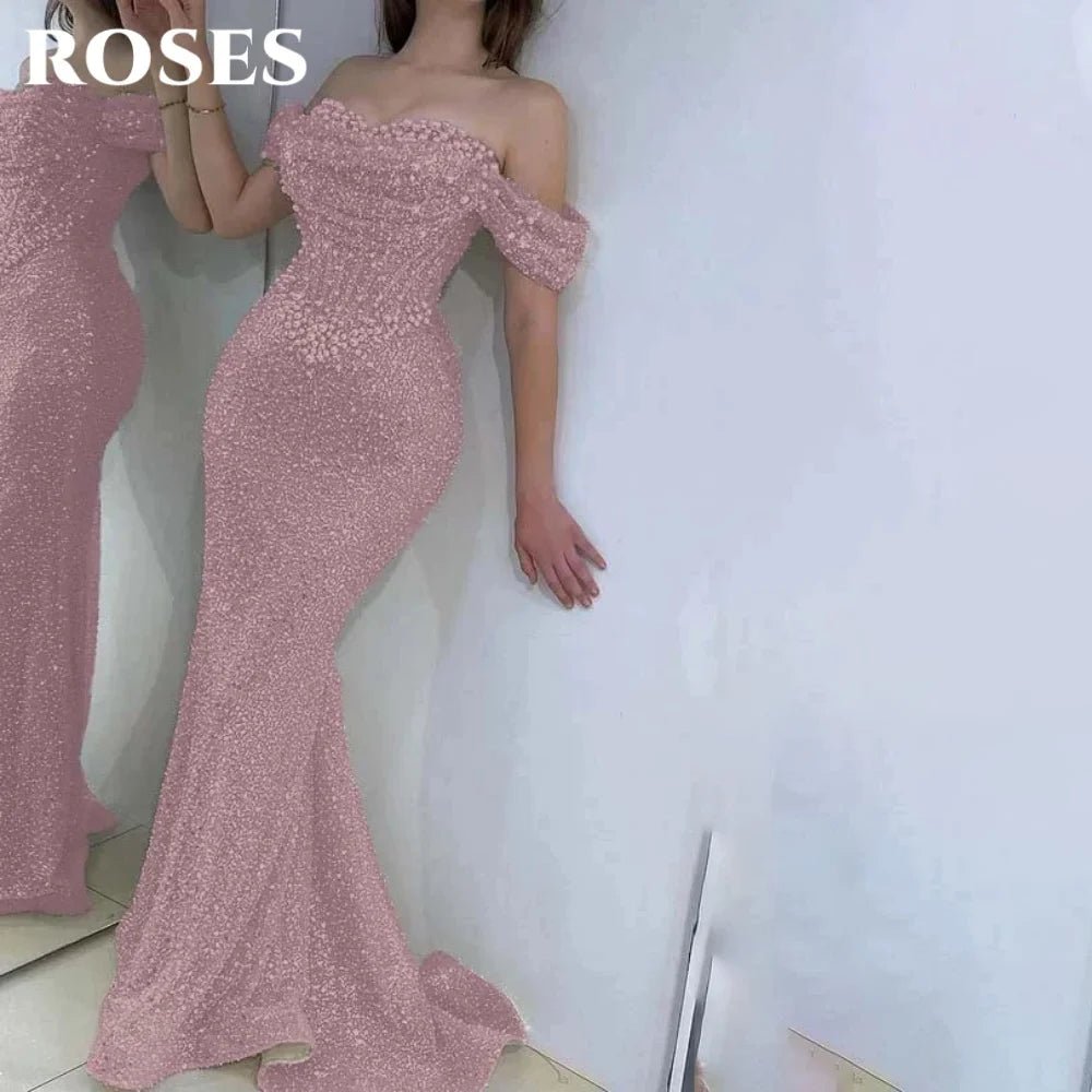 Pink off-shoulder beaded gown with 'ROSES' text on a white background