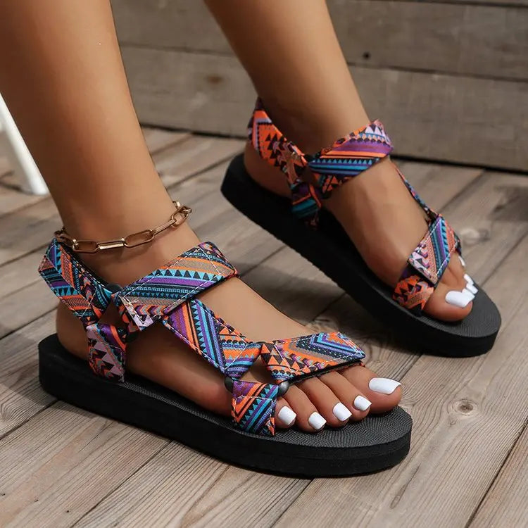 Colorful sandals with geometric patterns on a wooden floor