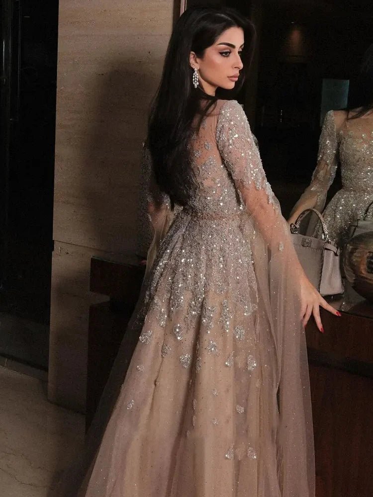 Woman in a sparkling evening gown standing indoors.
