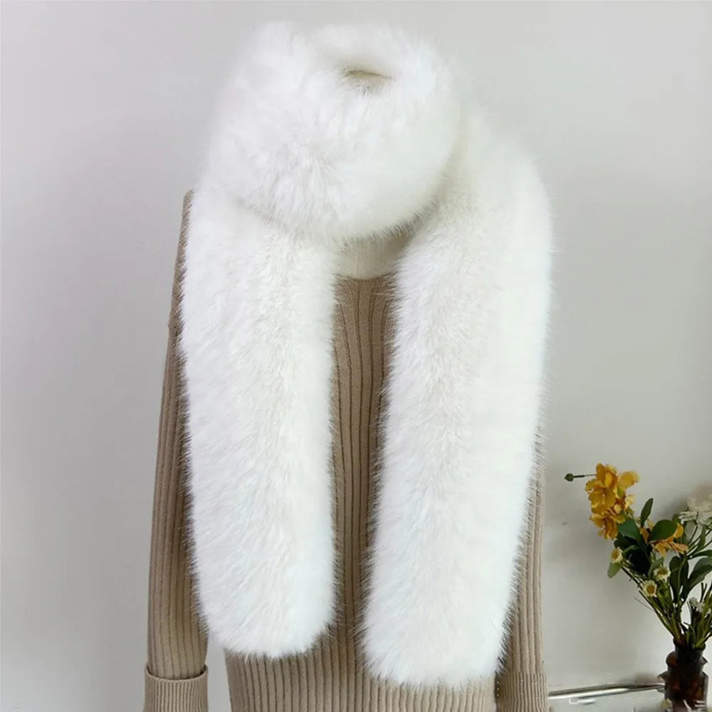 White fur scarf draped over a beige sweater with a neutral background