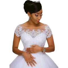 Woman wearing a white lace wedding dress on a white background